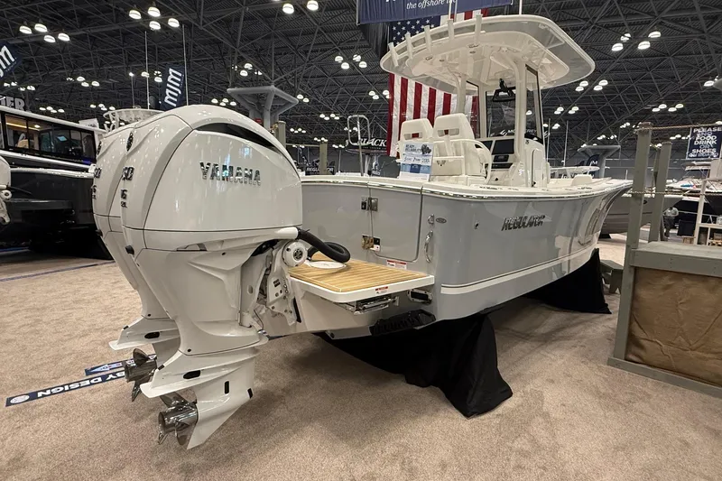 Slide: The Image of 2026 Regulator 25 boat with Yamaha engines displayed at an indoor boat show. - 9
