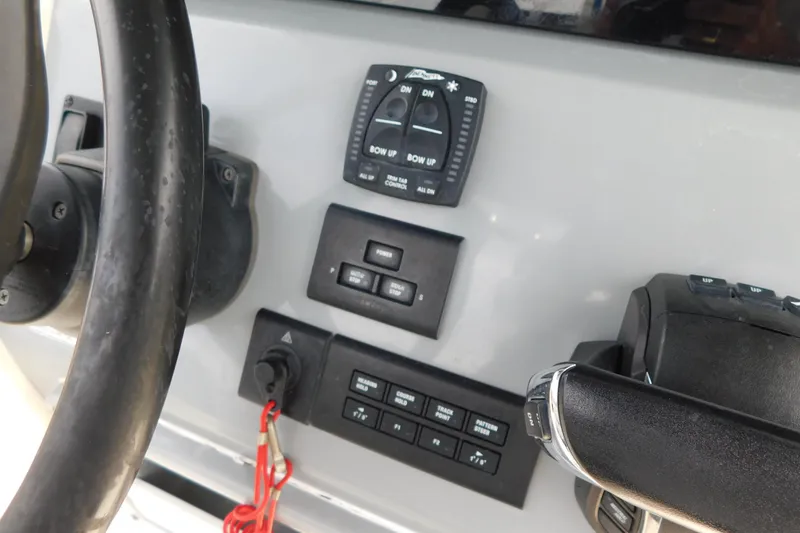 Slide: The Image of 2021 Cobia 262 Center Console boat dashboard with steering wheel and control panel. - 12