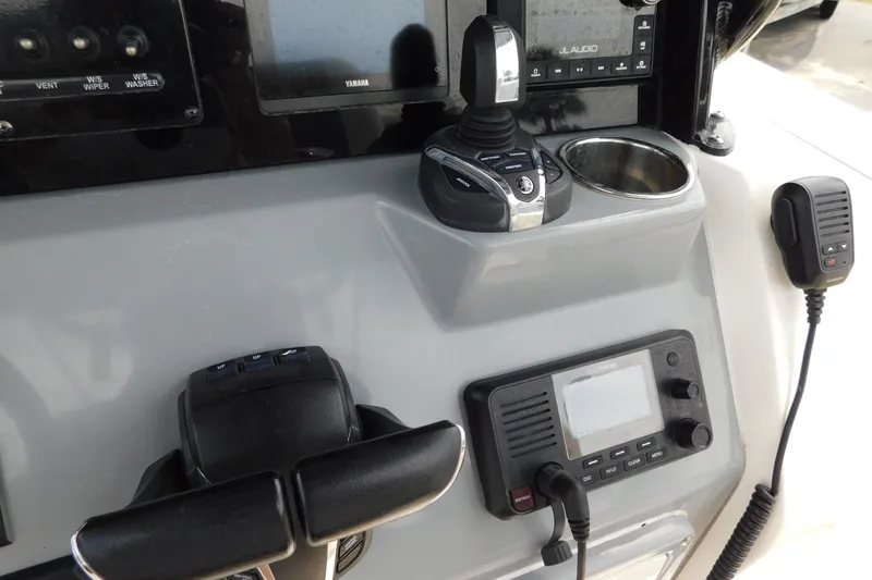 Slide: The Image of 2021 Cobia 262 Center Console dashboard with controls and communication devices. - 13