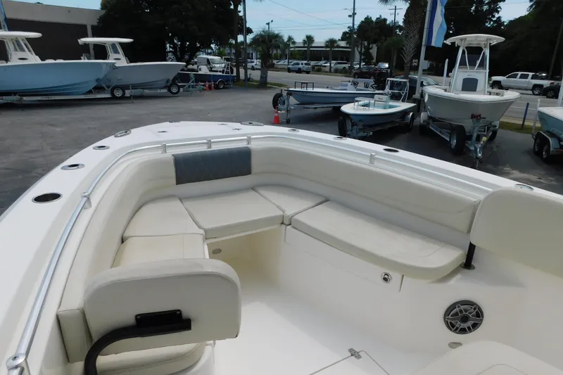 Slide: The Image of 2021 Cobia 262 Center Console boat with spacious seating, displayed outdoors. - 17