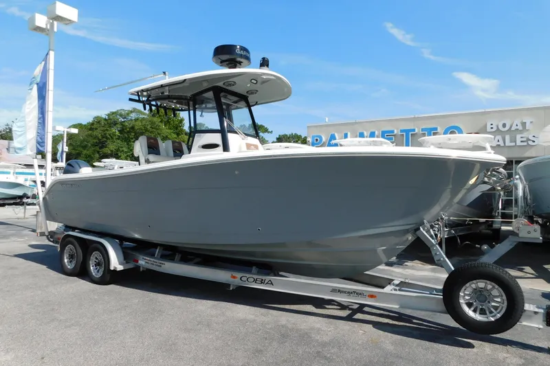 Slide: The Image of 2021 Cobia 262 Center Console boat on trailer at dealership. - 2
