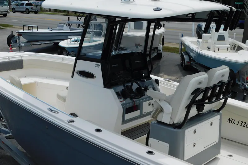 Slide: The Image of 2021 Cobia 262 Center Console boat with dual seating and modern dashboard. - 23