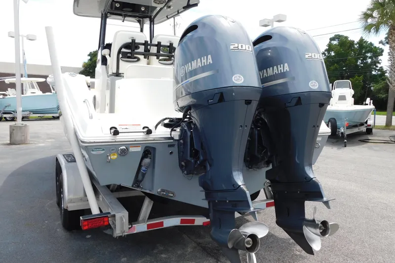 Slide: The Image of 2021 Cobia 262 Center Console with dual Yamaha 200 engines on a trailer. - 27