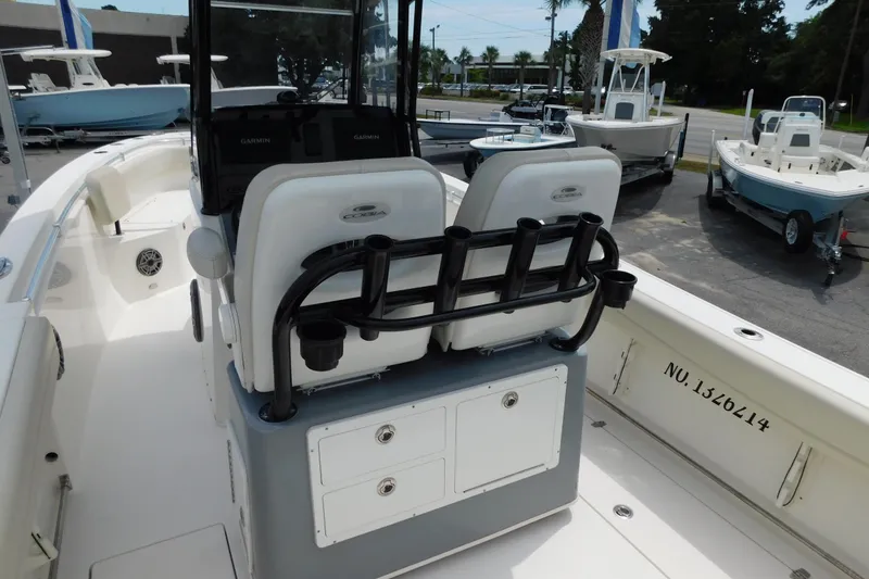 Slide: The Image of 2021 Cobia 262 Center Console boat interior with seating and rod holders. - 28