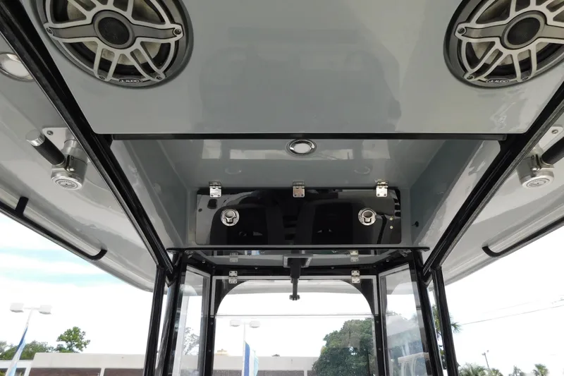 Slide: The Image of 2021 Cobia 262 Center Console boat interior with speakers and storage compartment. - 29