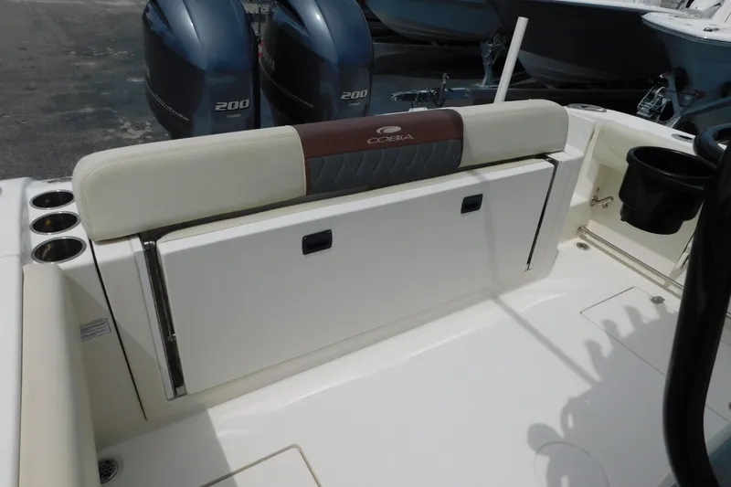 Slide: The Image of 2021 Cobia 262 Center Console boat interior with dual engines and seating area. - 32