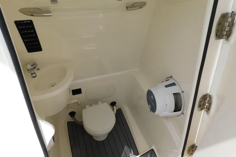 Slide: The Image of 2021 Cobia 262 Center Console boat bathroom with sink and toilet. - 34