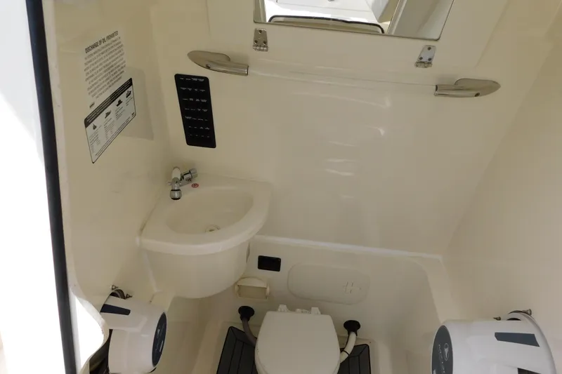 Slide: The Image of 2021 Cobia 262 Center Console boat interior with sink and toilet. - 35