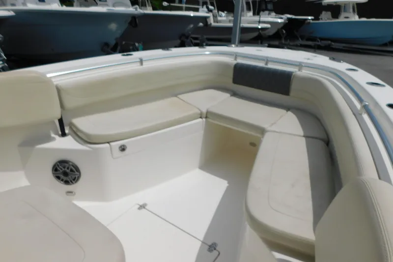 Slide: The Image of 2021 Cobia 262 Center Console boat interior with cushioned seating and speaker. - 36