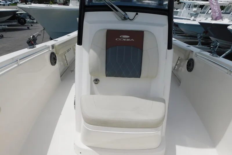 Slide: The Image of 2021 Cobia 262 Center Console boat interior with cushioned seating and speaker. - 37