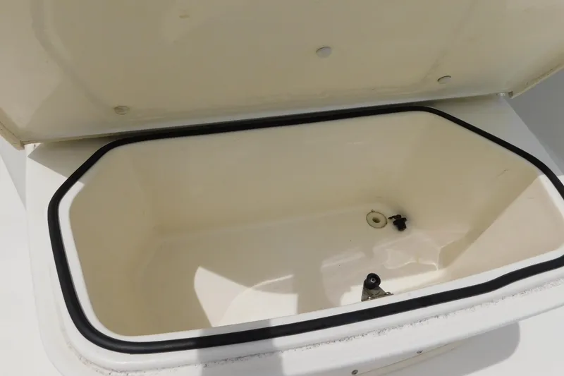 Slide: The Image of Open storage compartment on 2021 Cobia 262 Center Console boat. - 39