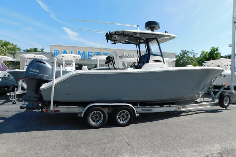 Slide: The Image of 2021 Cobia 262 Center Console boat on trailer at dealership, featuring Yamaha engine. - 4