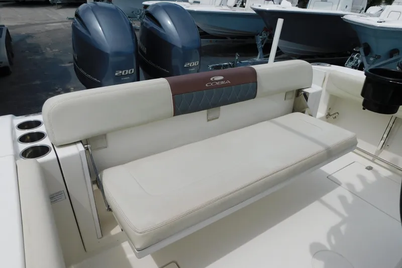 Slide: The Image of 2021 Cobia 262 Center Console boat with cushioned seating and dual Yamaha 200 engines. - 41