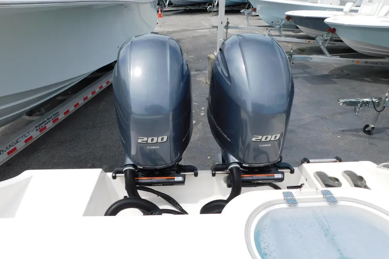 Slide: The Image of 2021 Cobia 262 Center Console with twin Yamaha 200 engines, docked on trailer. - 42