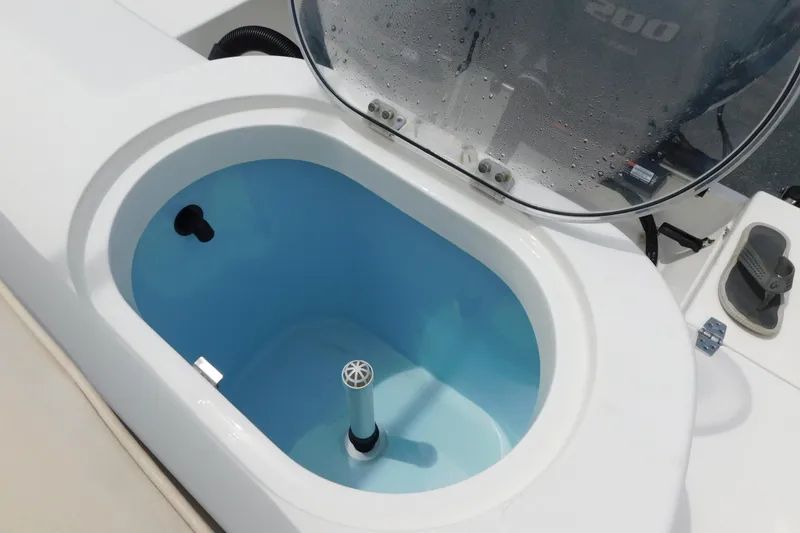 Slide: The Image of Livewell on 2021 Cobia 262 Center Console boat, open lid, blue interior. - 43