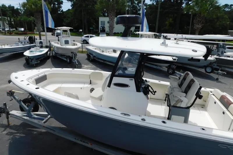 Slide: The Image of 2021 Cobia 262 Center Console boat displayed at a dealership. - 6