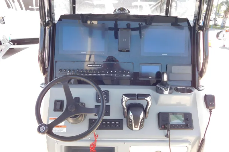 Slide: The Image of 2021 Cobia 262 Center Console dashboard with steering wheel and electronic displays. - 8