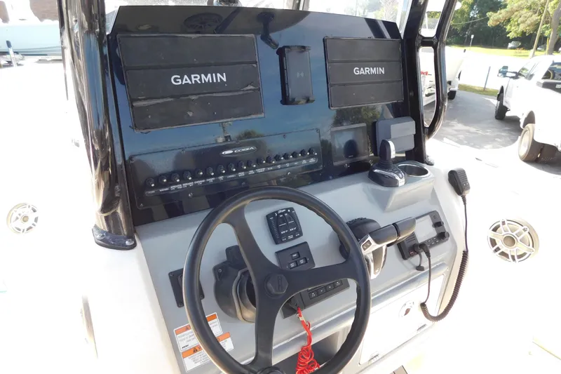 Slide: The Image of 2021 Cobia 262 Center Console dashboard with Garmin navigation system and steering wheel. - 9