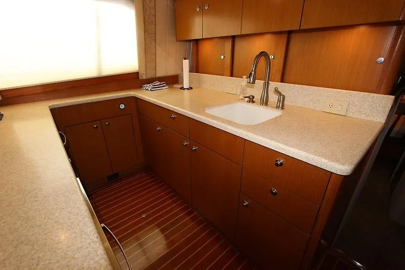 Slide: The Image of Luxurious 2002 Ocean Yachts kitchen with wooden cabinets and modern sink. - 10