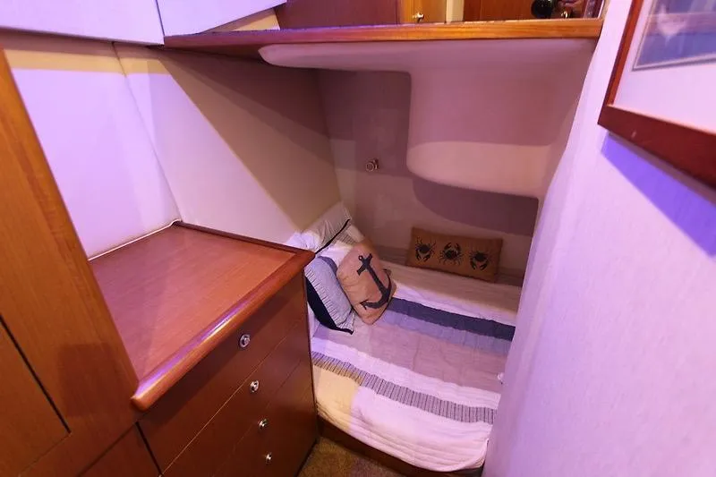 Slide: The Image of Cozy cabin interior of 2002 Ocean Yachts, featuring a bed with nautical-themed decor. - 18