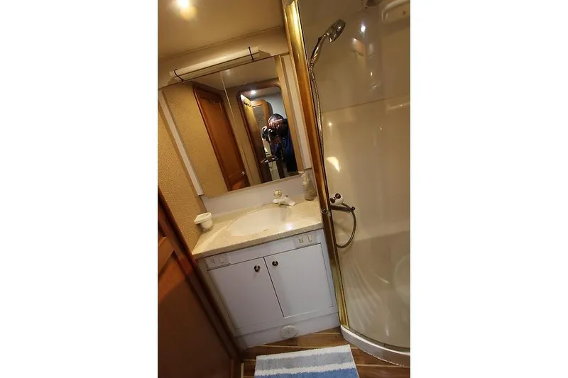 Slide: The Image of Bathroom interior of 2002 Ocean Yachts model, featuring a shower and vanity. - 19