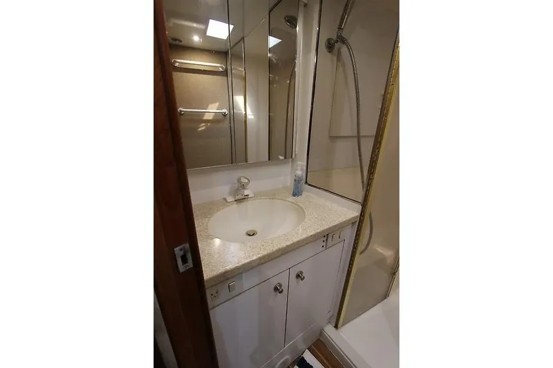 Slide: The Image of Luxurious 2002 Ocean Yachts bathroom with sink, mirror, and shower. - 20