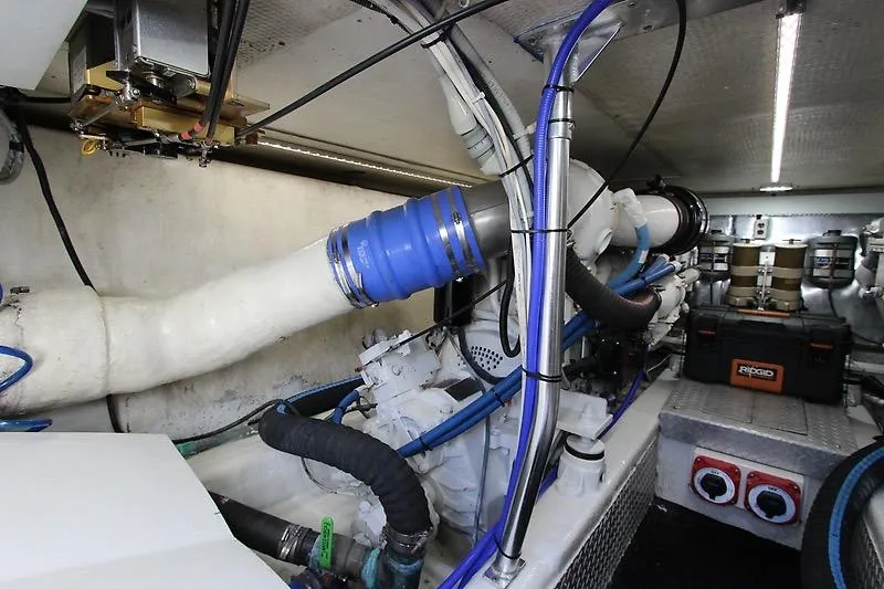 Slide: The Image of Engine room of a 2002 Ocean Yachts vessel, featuring pipes and mechanical components. - 21