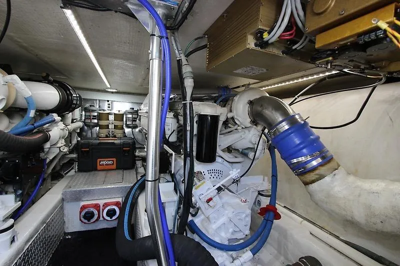 Slide: The Image of Engine room of 2002 Ocean Yachts model, showcasing mechanical components and wiring. - 23