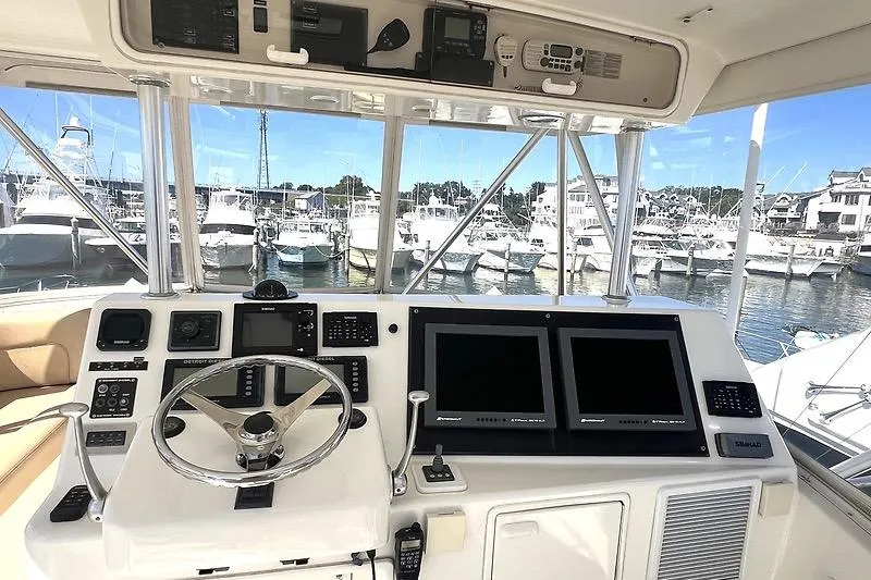 Slide: The Image of Helm of 2002 Ocean Yachts model, featuring advanced navigation equipment and marina view. - 4
