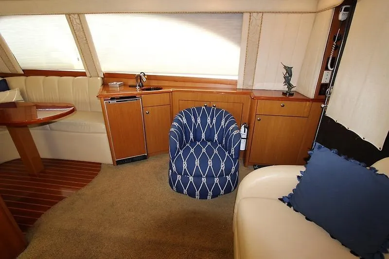 Slide: The Image of Interior of 2002 Ocean Yachts model, featuring elegant seating and wooden cabinetry. - 7