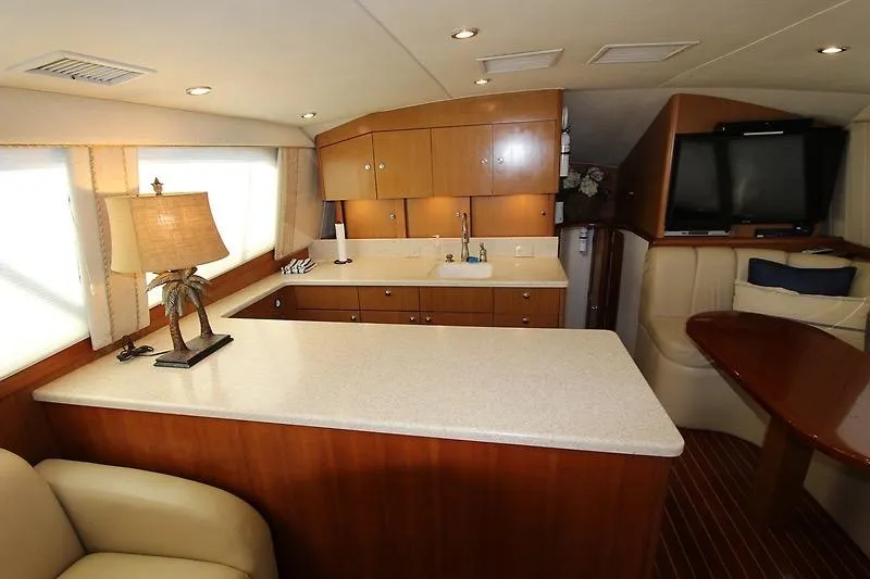 Slide: The Image of Luxurious 2002 Ocean Yachts interior with modern kitchen and cozy seating area. - 9
