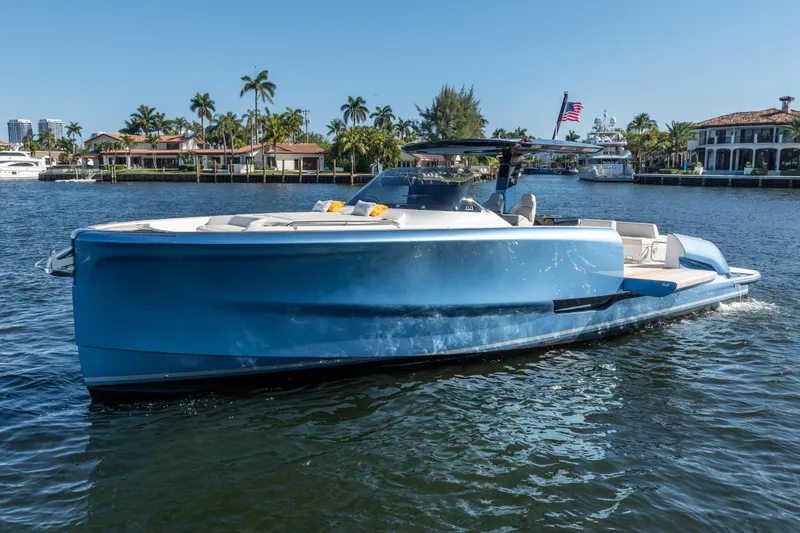 Slide: The Image of 2025 Solaris Power 44 Open yacht cruising on a sunny waterfront with palm trees. - 11