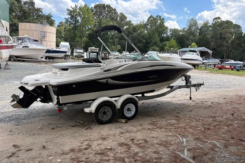 Slide: The Image of 2008 Sea Ray 195 Sport boat on trailer in outdoor storage area. - 2
