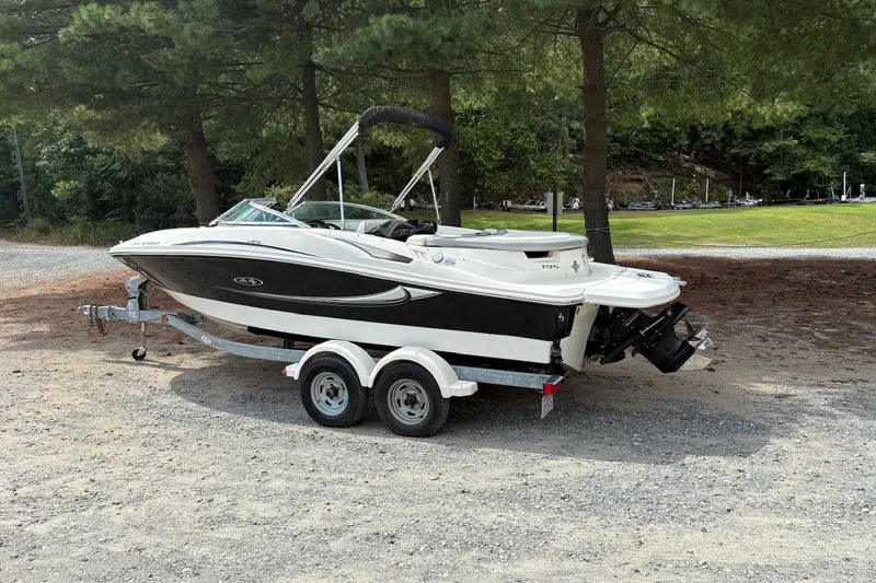 Slide: The Image of 2008 Sea Ray 195 Sport boat on trailer, parked outdoors near trees. - 3