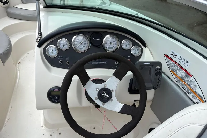 Slide: The Image of 2008 Sea Ray 195 Sport boat dashboard with steering wheel and gauges. - 5