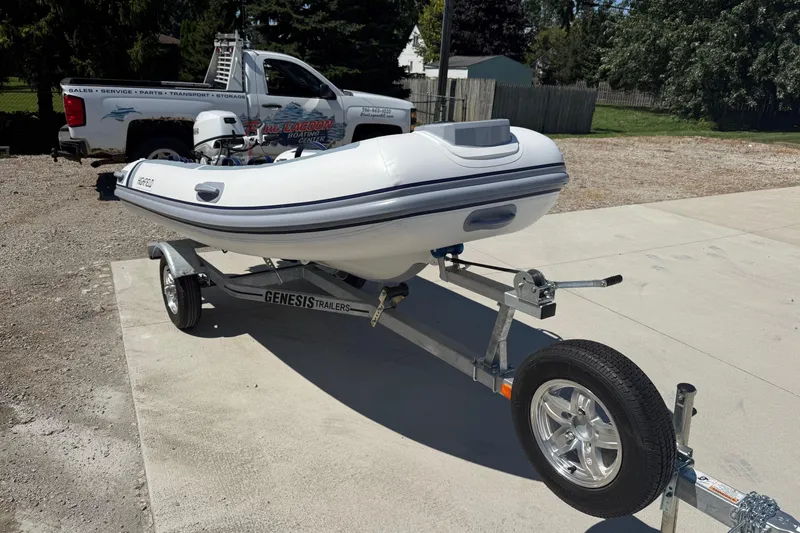 Slide: The Image of 2024 Highfield Classic 340 boat on Genesis trailer, parked outdoors. - 2