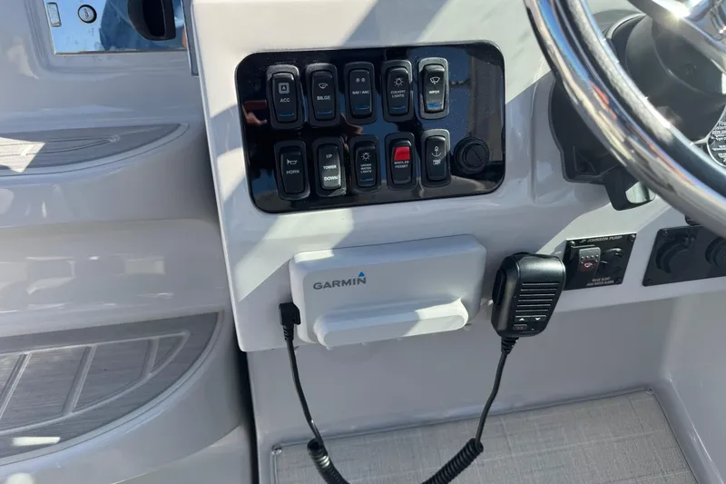 Slide: The Image of 2024 Regal 26 XO boat dashboard with Garmin device and control panel. - 14