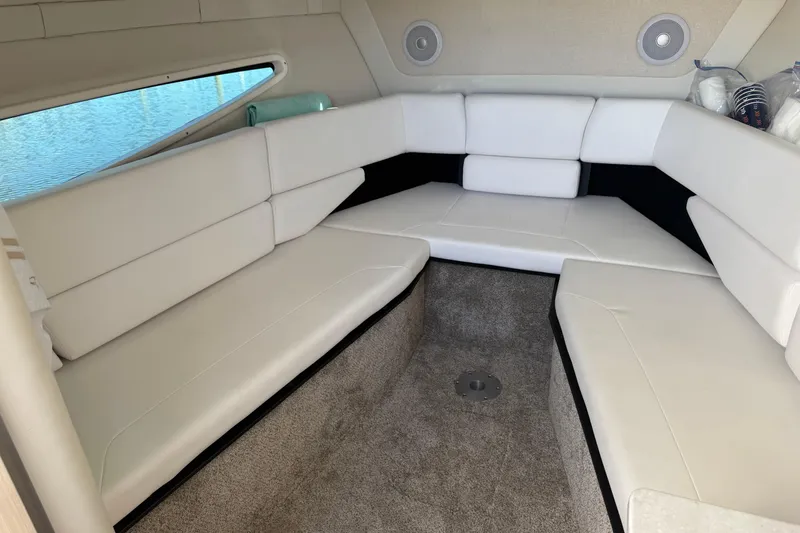 Slide: The Image of 2024 Regal 26 XO boat interior with white seating and carpeted floor. - 15