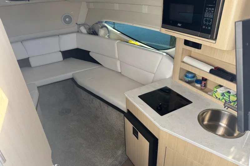 Slide: The Image of 2024 Regal 26 XO cabin interior with kitchenette, seating, and modern amenities. - 21