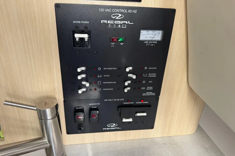 Slide: The Image of Control panel of 2024 Regal 26 XO boat, featuring various switches and indicators. - 23