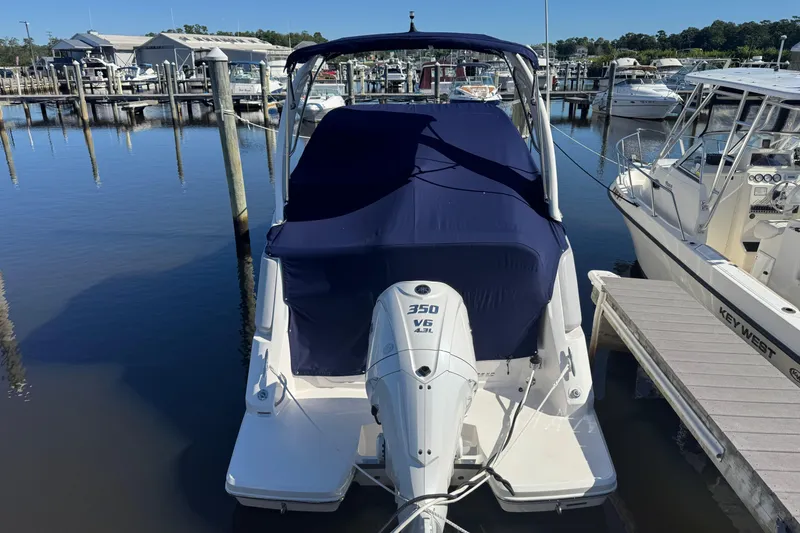 Slide: The Image of 2024 Regal 26 XO boat with 350 V6 engine docked at marina. - 3