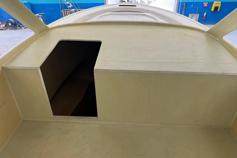Slide: The Image of 2025 Xcelerator Walk Around boat interior under construction in a workshop. - 10