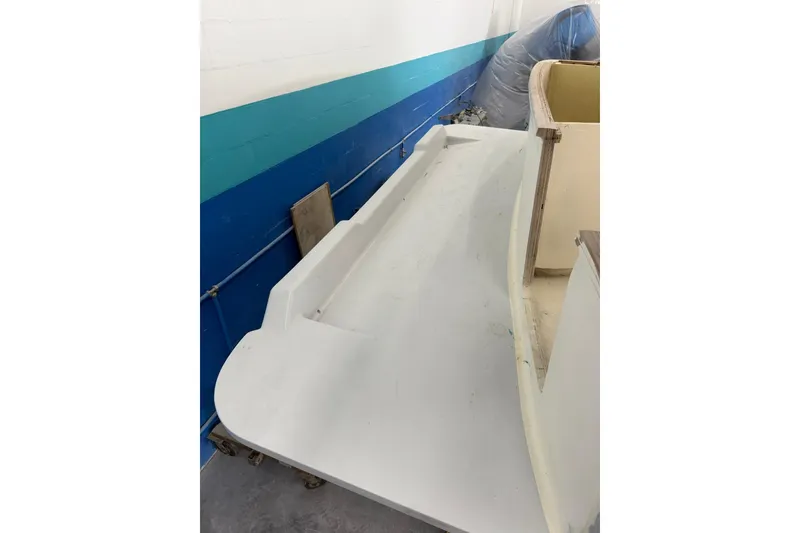 Slide: The Image of 2025 Xcelerator Walk Around boat deck under construction in a workshop. - 11