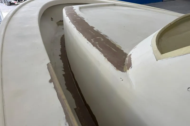 Slide: The Image of 2025 Xcelerator Walk Around boat under construction, showcasing unfinished deck details. - 4