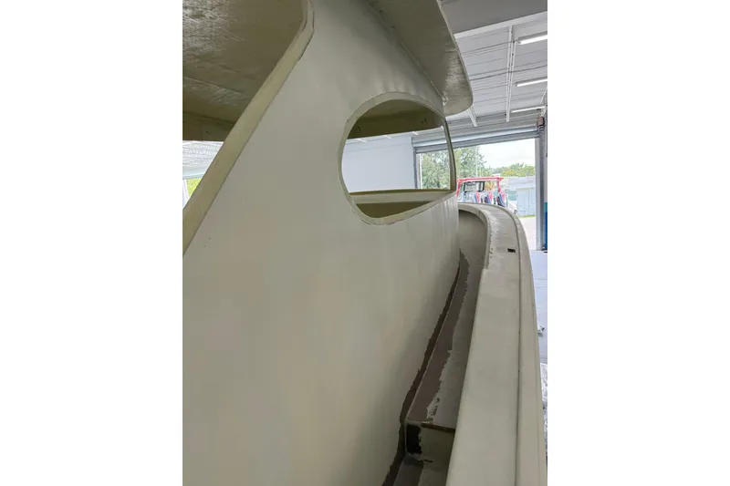 Slide: The Image of 2025 Xcelerator Walk Around boat under construction in a workshop. - 5