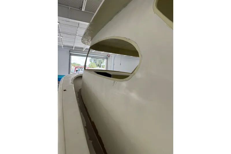 Slide: The Image of 2025 Xcelerator Walk Around boat under construction in a workshop. - 6