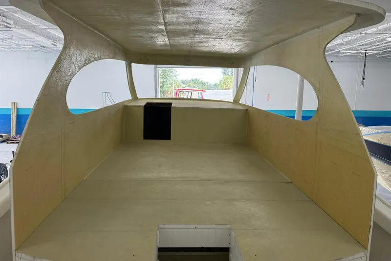 Slide: The Image of 2025 Xcelerator Walk Around boat interior under construction in a workshop. - 8