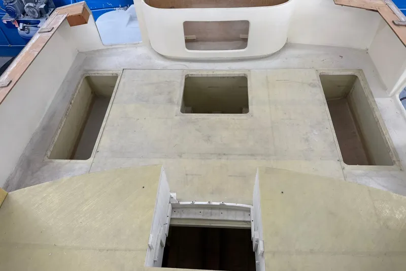 Slide: The Image of 2025 Xcelerator Walk Around boat interior with open compartments and unfinished surfaces. - 9