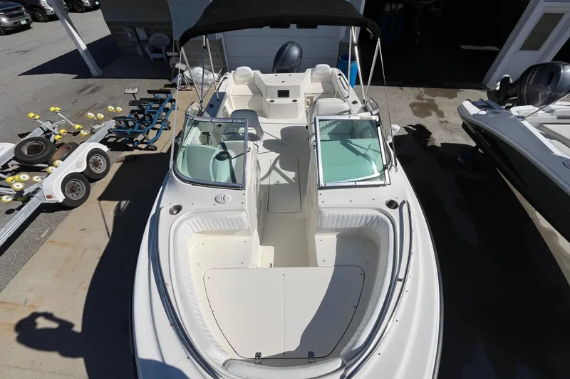 Slide: The Image of 2006 Hydra-Sports Lightning 202 DC boat with dual consoles and seating, docked outdoors. - 13