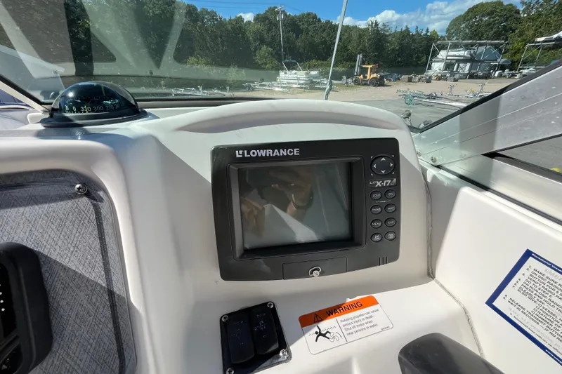 Slide: The Image of 2006 Hydra-Sports Lightning 202 DC dashboard with Lowrance fishfinder and compass. - 19